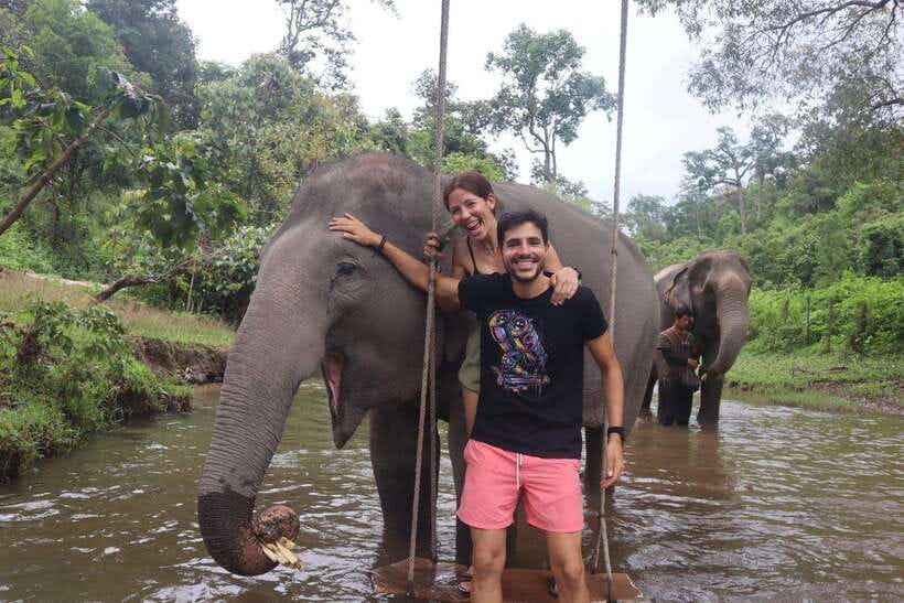 Chiang Mai: Elephant Sanctuary & Waterfall Group Tour - Cooling off in the river with the elephants