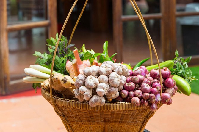 Chiang Mai Home Cooking Class with Garden Tour & Hotel Transfers - Picking herbs in the tropical garden